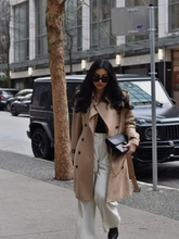 A girl wears a worsted wool trench coat